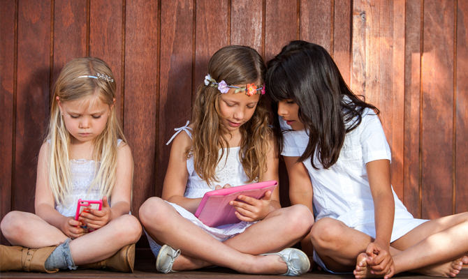 Small Girls Playing On Smart Devices